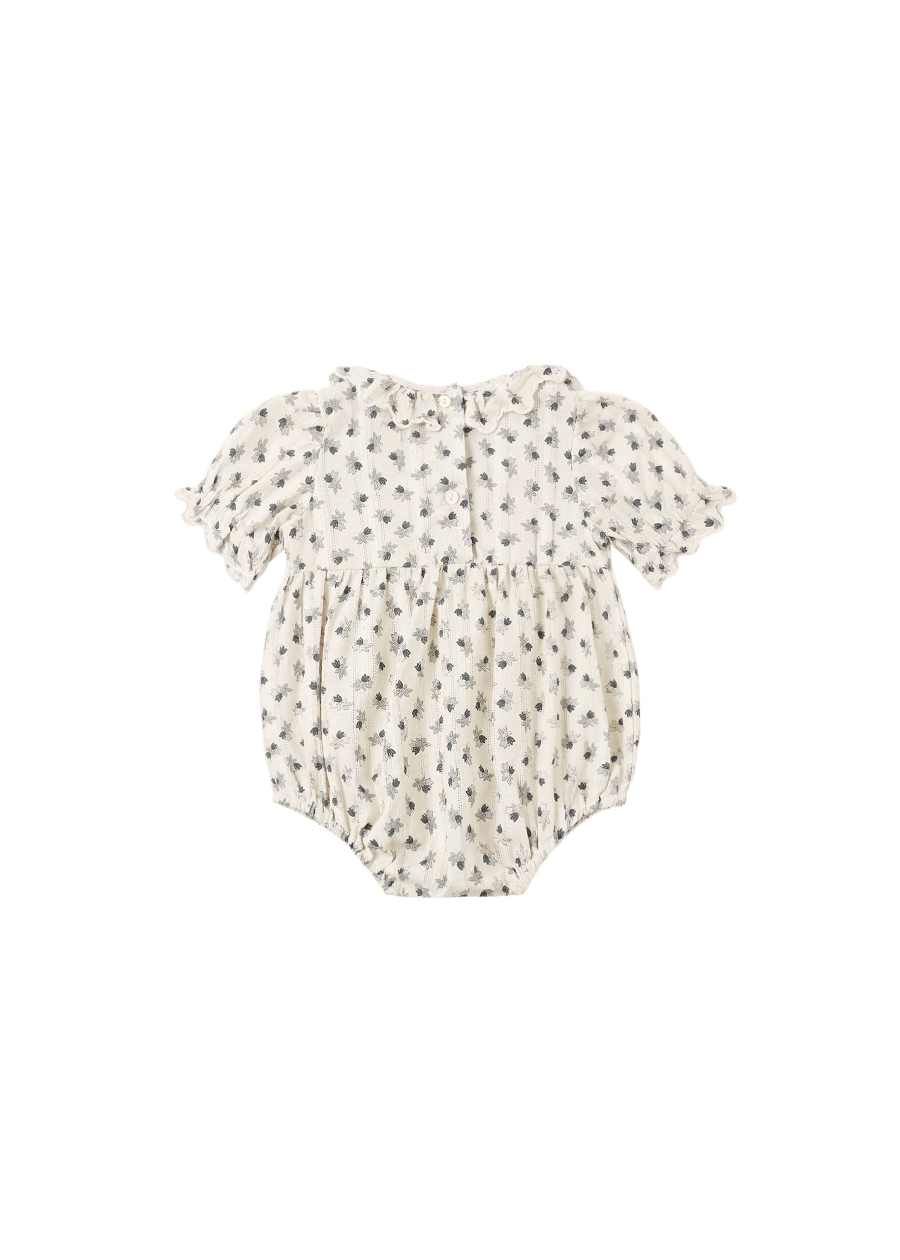 A baby romper in cream with a small dark floral print, featuring short ruffled sleeves and a ruffled neckline, shown against a plain white background.
