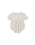 A baby romper in cream with a small dark floral print, featuring short ruffled sleeves and a ruffled neckline, shown against a plain white background.