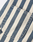 Close-up of blue and white striped fabric with a pocket detail.