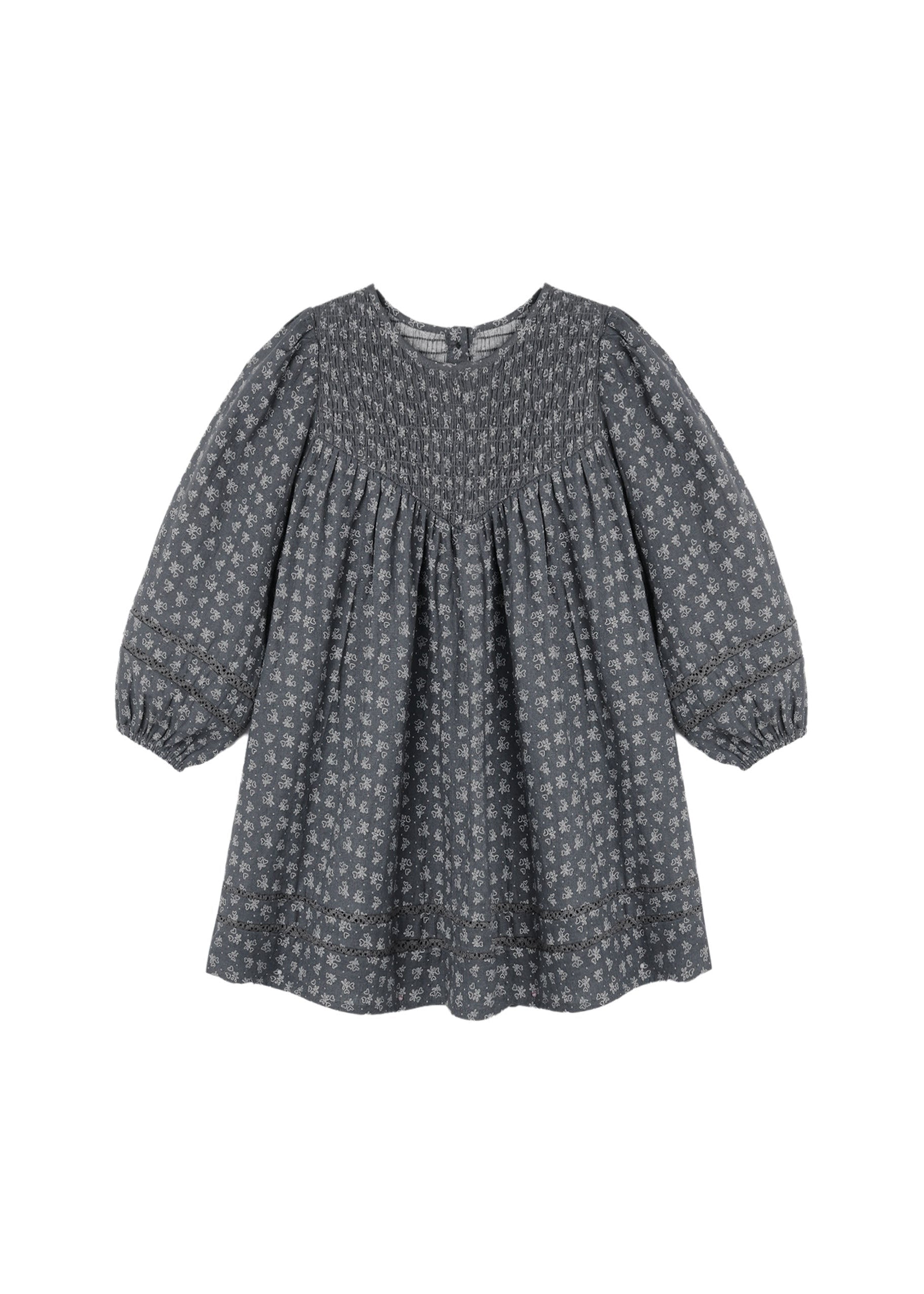 A dark gray long-sleeve blouse with a small white floral pattern, featuring a smocked bodice and gathered sleeves, shown against a plain white background.
