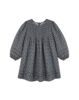 A dark gray long-sleeve blouse with a small white floral pattern, featuring a smocked bodice and gathered sleeves, shown against a plain white background.