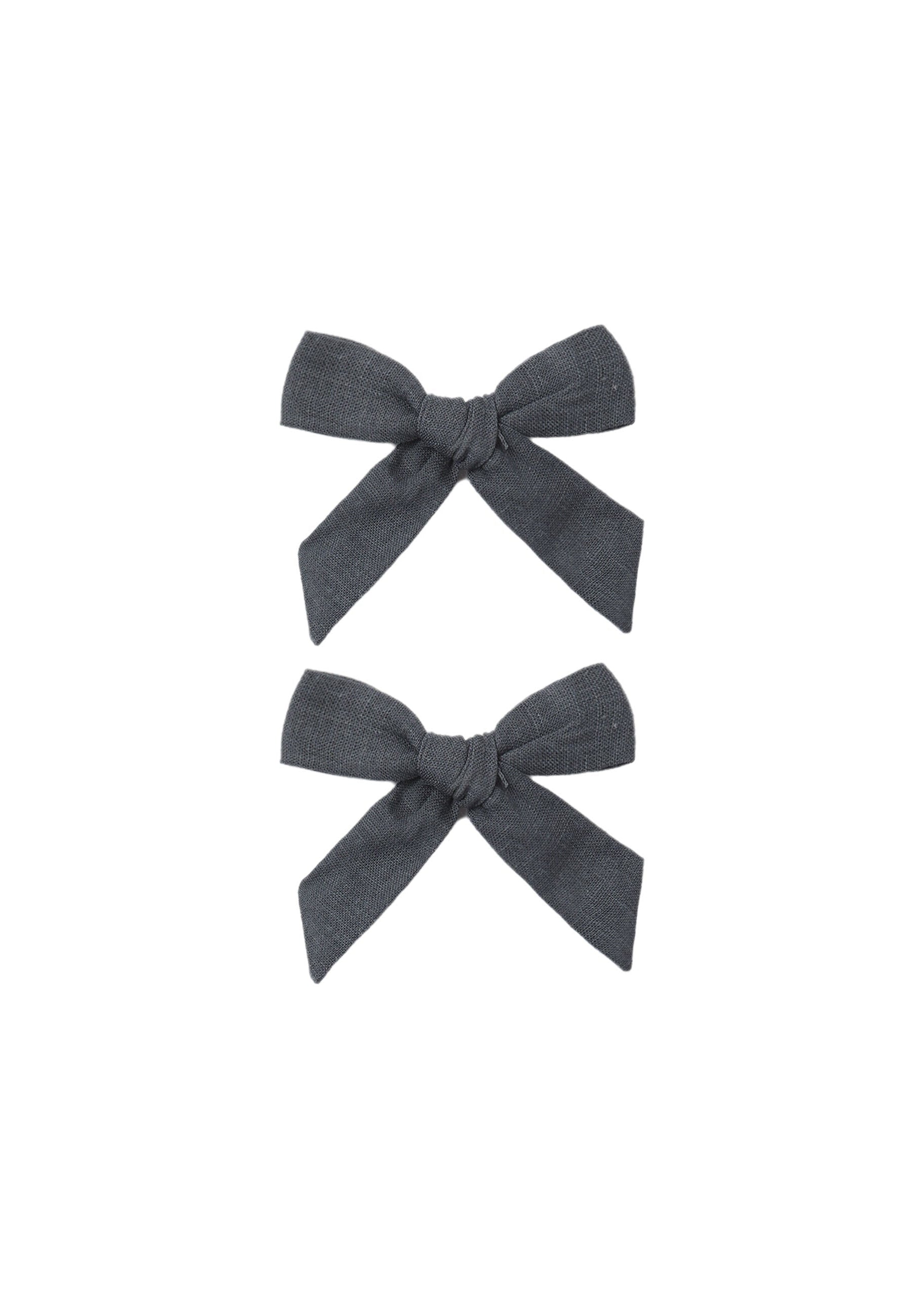 Two dark gray hair bows on a white background