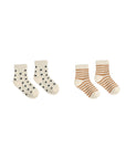 Two pairs of baby socks on a plain white background. The left pair is off-white with small black star patterns, and the right pair is cream with warm brown stripes.