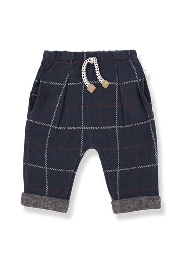 Navy plaid baby pants with a decorative bow on a white background