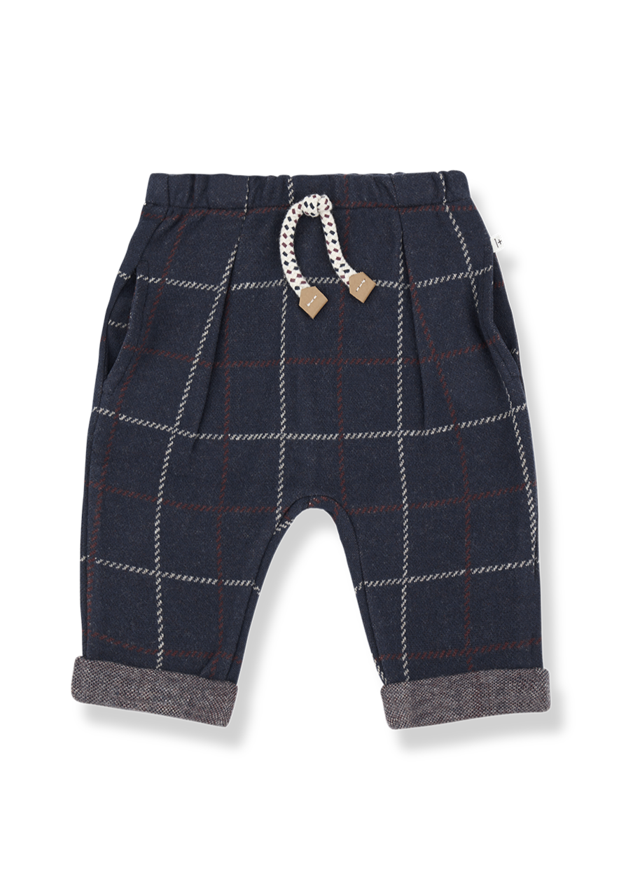 Navy plaid baby pants with a decorative bow on a white background