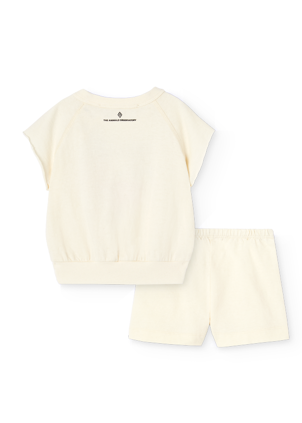 Set of cream-colored top and shorts with a brand logo on a white background