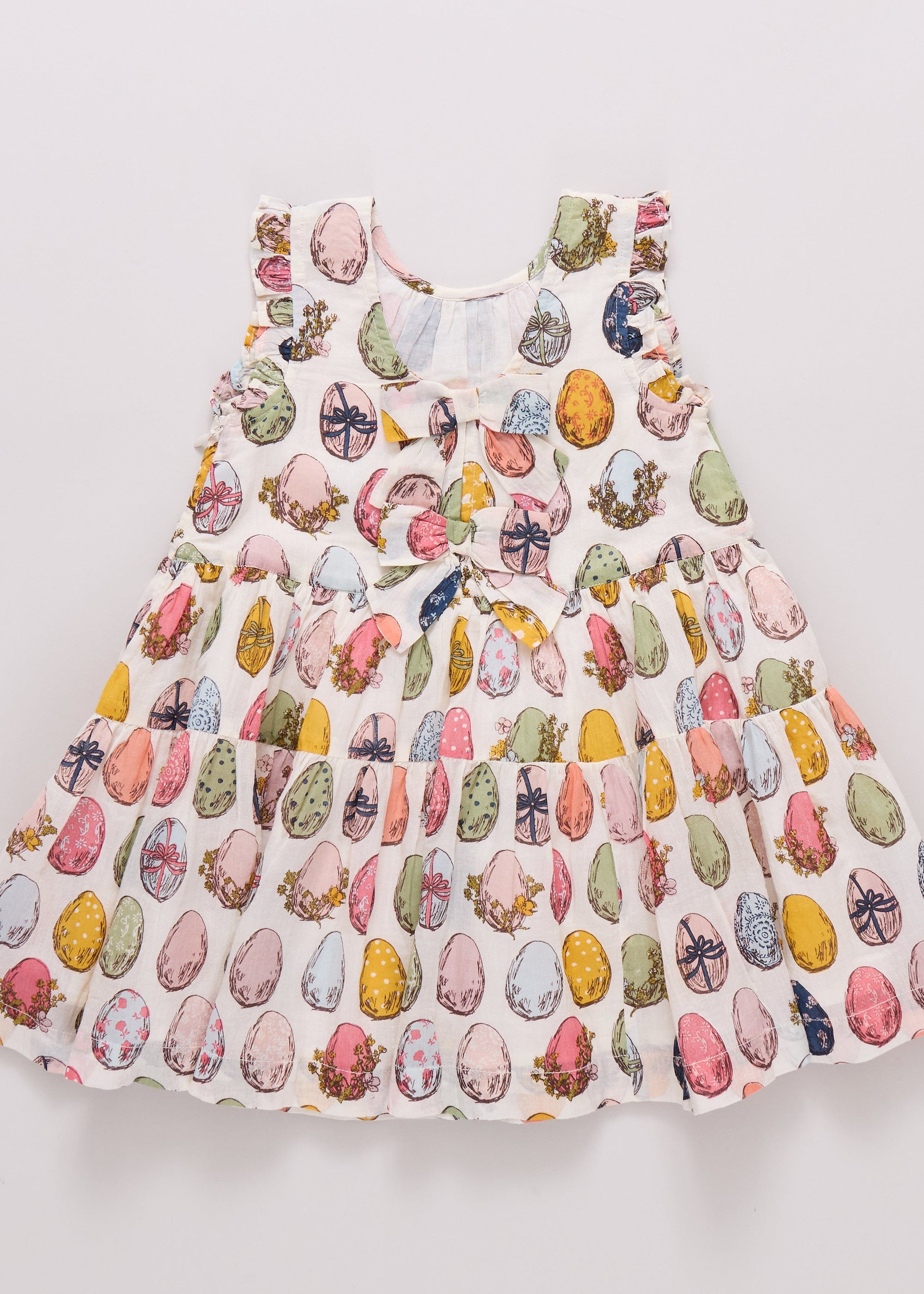 Children's dress with colorful pattern on a light gray background