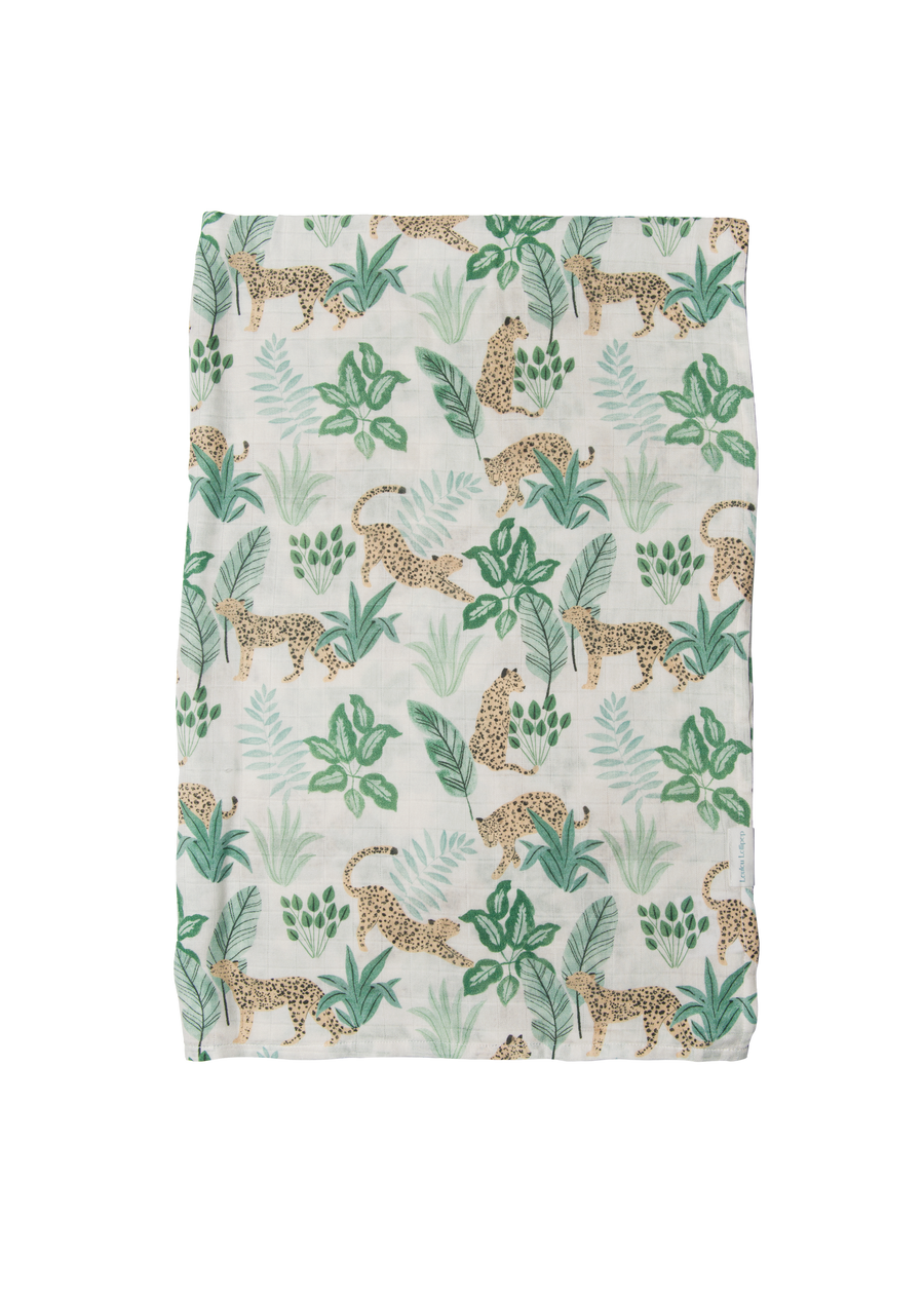Fabric with a pattern of leopards and tropical leaves on a white background
