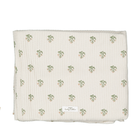 White textured blanket with green floral pattern on a transparent background