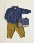 Children's clothing set with blue shirt, yellow striped pants, and gray sweater on a white background