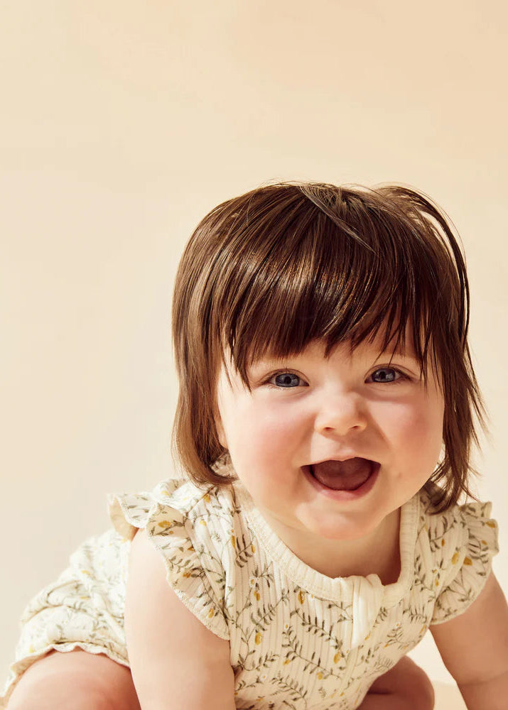 Child with a big smile on a beige background