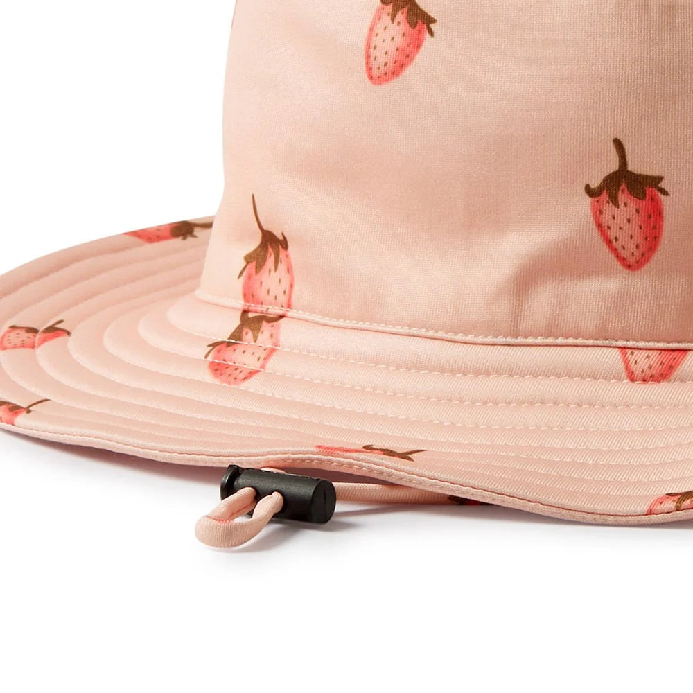 Pink bucket hat with strawberry pattern on a white background