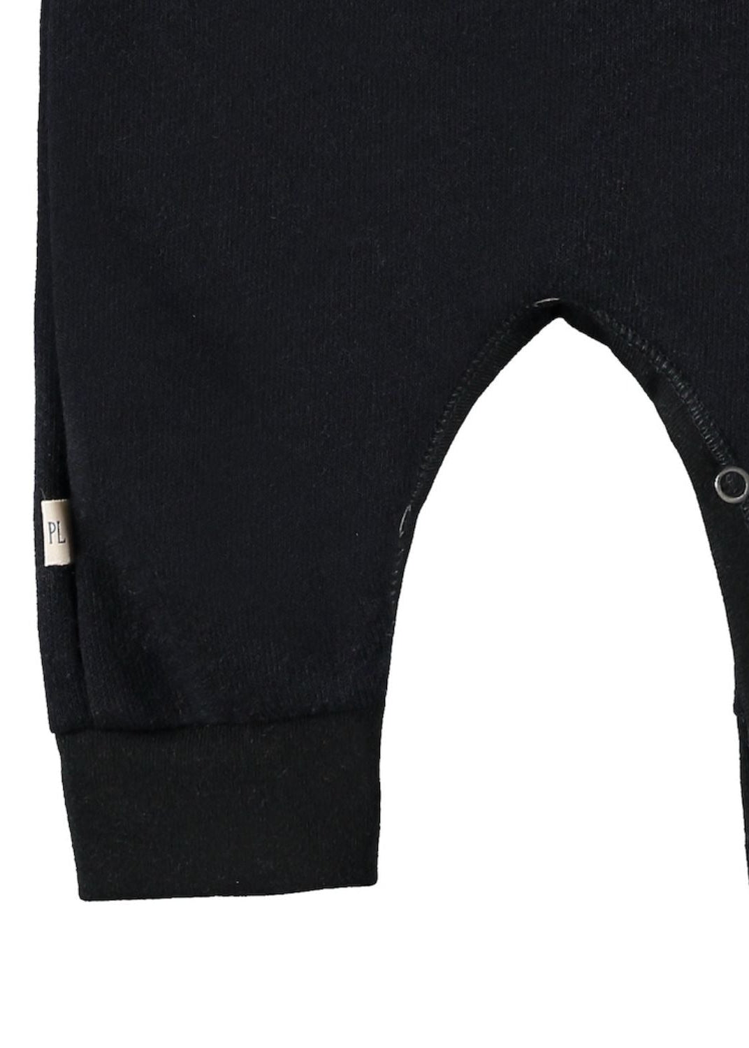 Close-up of a black baby romper with a brand label on a white background