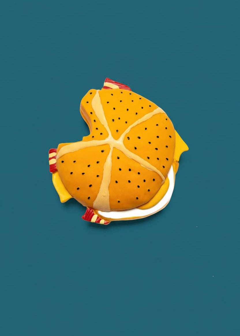 Illustration of a fish-shaped pizza on a blue background