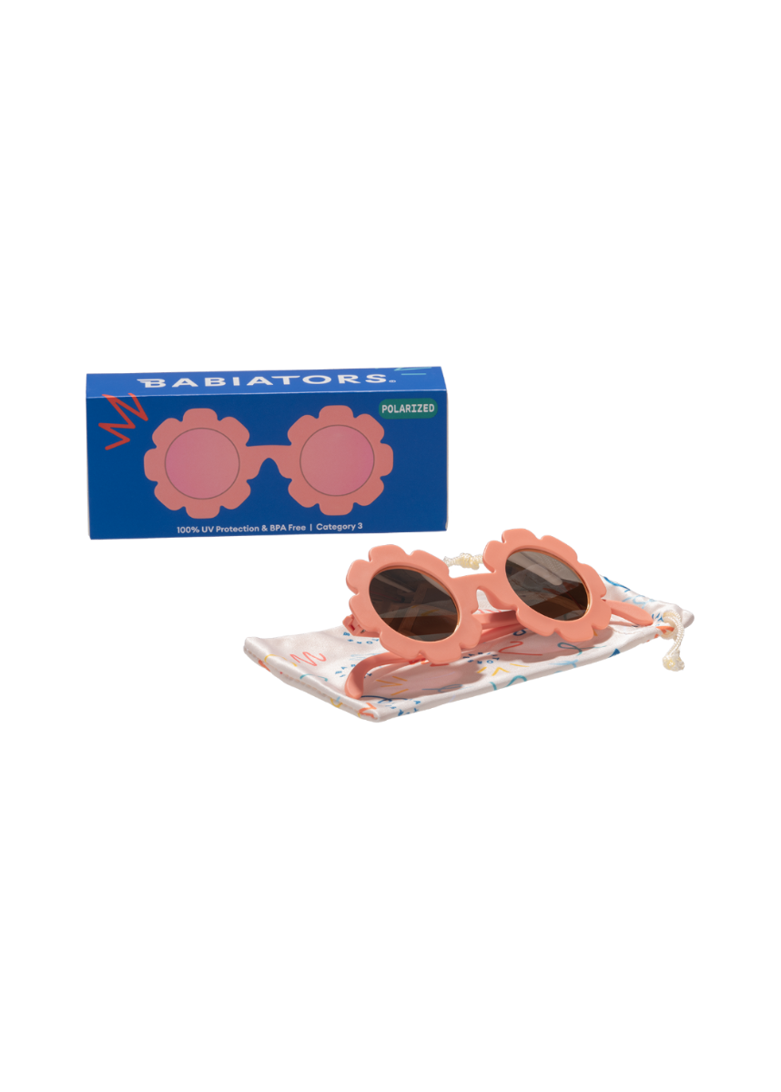 Children's sunglasses with floral design on a display stand and packaging box, featuring the brand 'Babiators'.