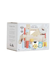 Wooden toy box packaging with toy illustrations on a light pink background