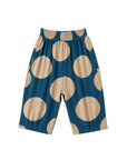 A pair of toddler shorts with a large beige polka dot pattern on a teal blue background, featuring an elastic waistband, shown flat on a light off-white background.