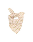 A light beige bandana or scarf tied in a knot, featuring a delicate all-over floral pattern in muted green and pink, set against a plain light gray background.