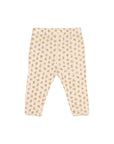 A pair of infant leggings with an all-over small floral print on a pale pink background, displayed flat against a light gray studio background.