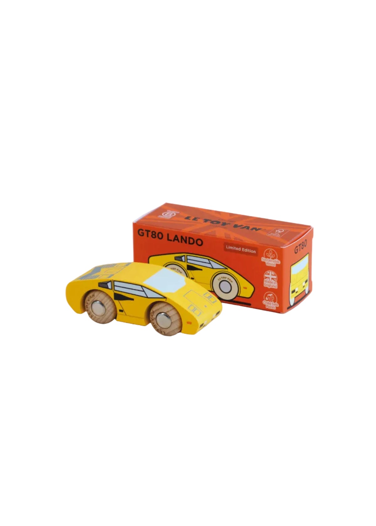 Yellow toy car next to its packaging box on a beige background