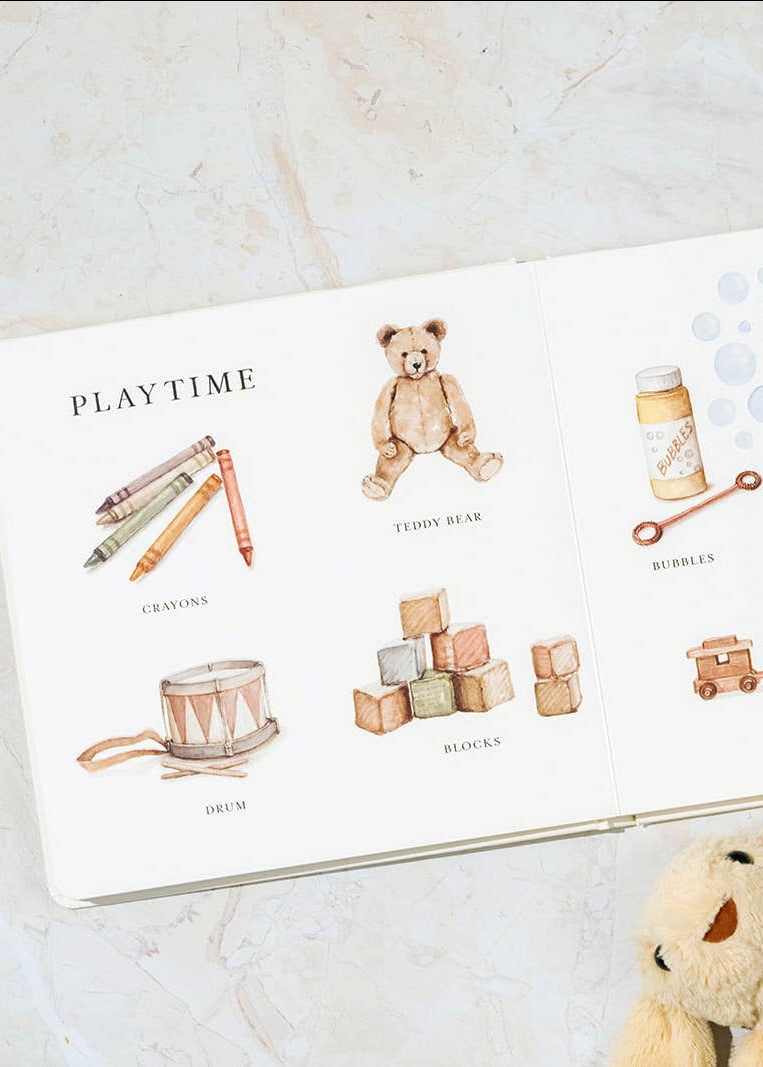 Children's book with illustrations of toys on a marble surface
