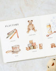 Children's book with illustrations of toys on a marble surface