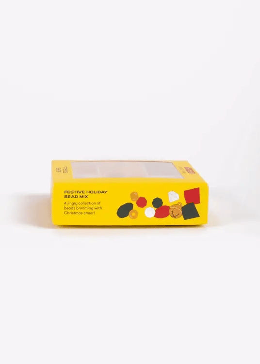 Yellow box of festive holiday bead mix on a white background