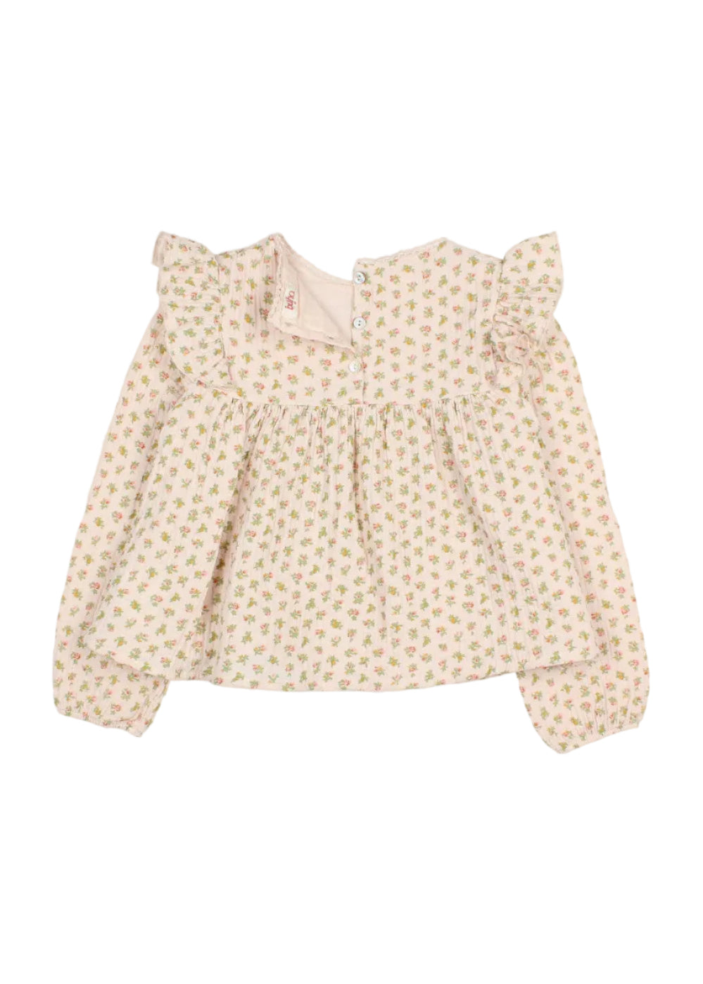 A baby girl's long-sleeve blouse with a delicate, all-over floral print in soft pink and green on a warm cream background. The top features ruffled shoulder details, a smocked waist, and a small fabric flower embellishment on the right shoulder.