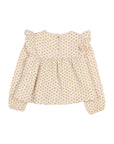 A baby girl's long-sleeve blouse with a delicate, all-over small floral print in soft green and orange on a warm cream background. The top features ruffled shoulder details, a gathered waist, and a small fabric flower applique on the upper right shoulder, presented flat on a light gray background.