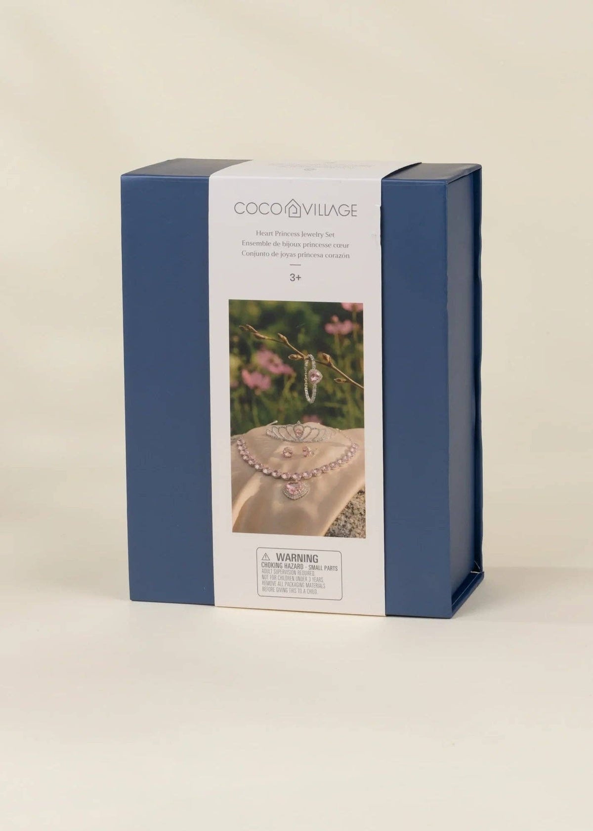 A rectangular product box for Coco Village hair jewelry, featuring a navy blue side design and a white front label with a photo of a pearl hairpiece and a ring, set against a plain beige background.