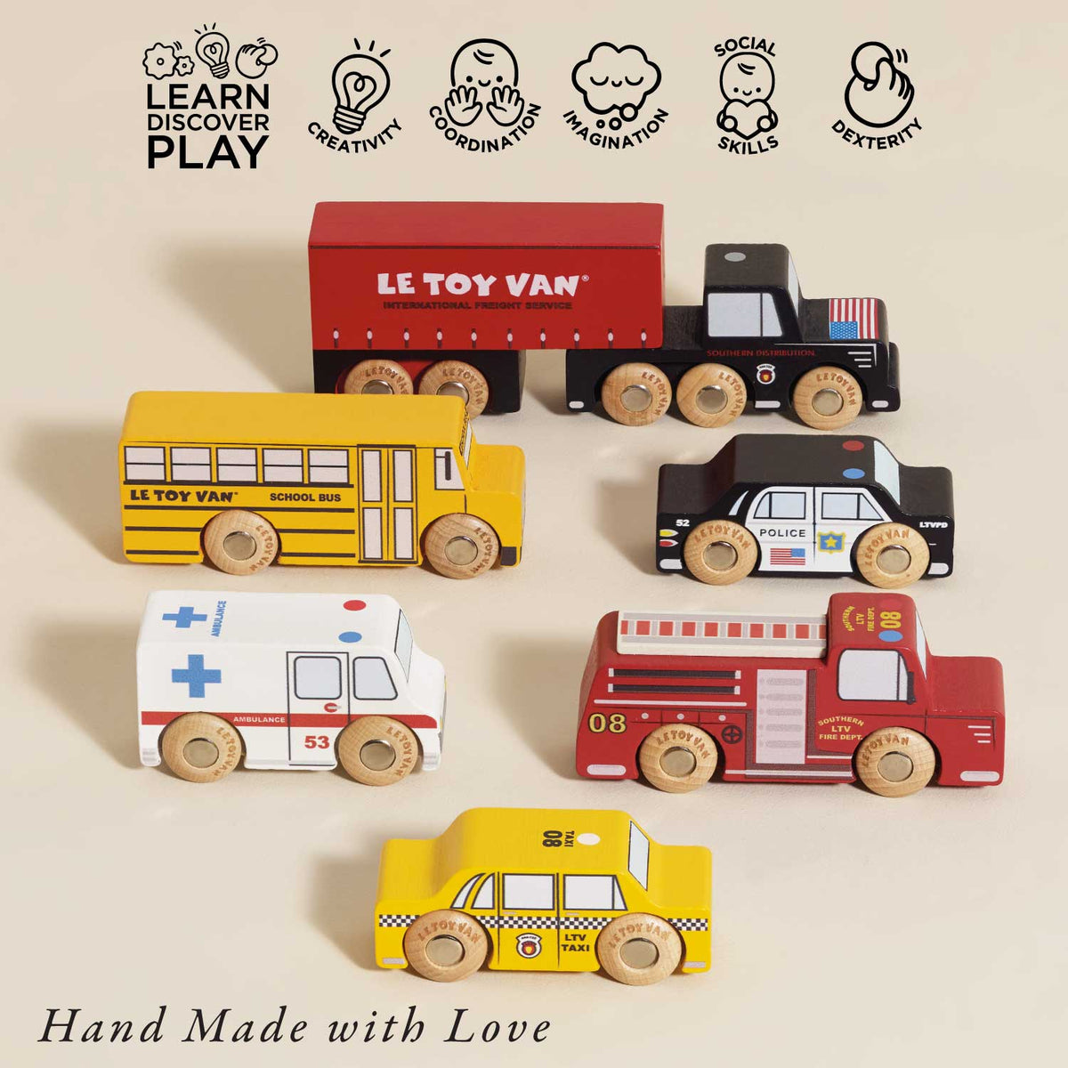 Set of wooden toy vehicles including a truck, school bus, ambulance, and taxi on a beige background with 'Le Toy Van' branding.