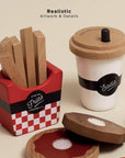 Set of wooden food props including fries, a cup with a lid, and saltshakers on a beige background.