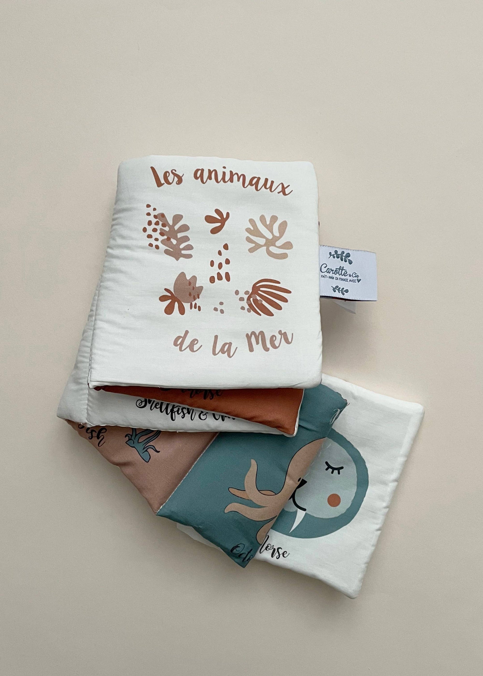 Folded fabric with animal-themed design on a beige background