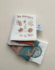 Folded fabric with animal-themed design on a beige background