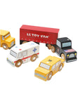 Set of wooden toy vehicles including a school bus, truck, ambulance, and taxi on a white background with 'Le Toy Van' branding.