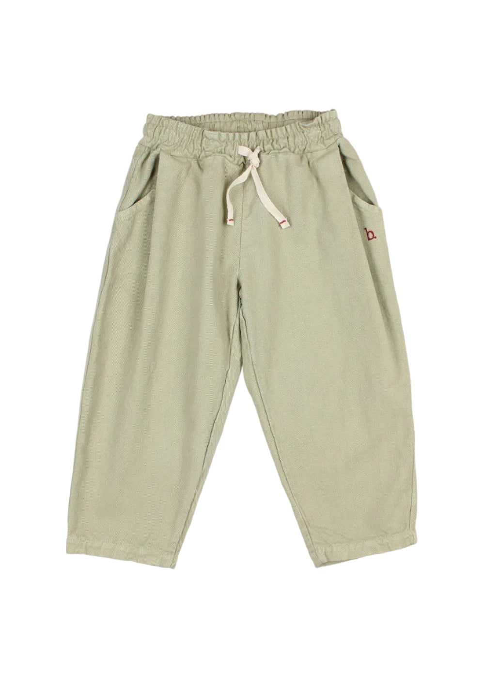 A pair of light sage green children's jogger pants with an elastic waistband, cream-colored drawstring, and side pockets, shown against a plain light gray background.