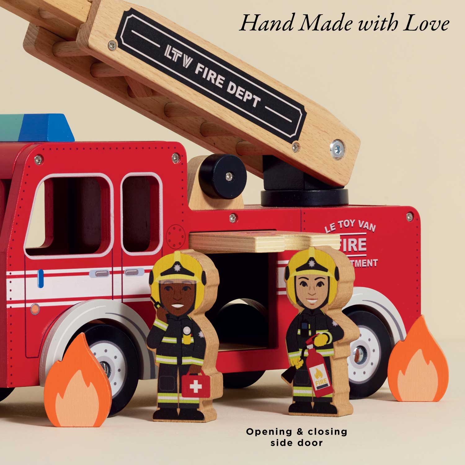 Toy fire truck with wooden ladder and firefighters in front, labeled 'Le Toy Van Fire Department'.