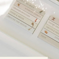 Set of 10 baby board books with categories on a white surface.
