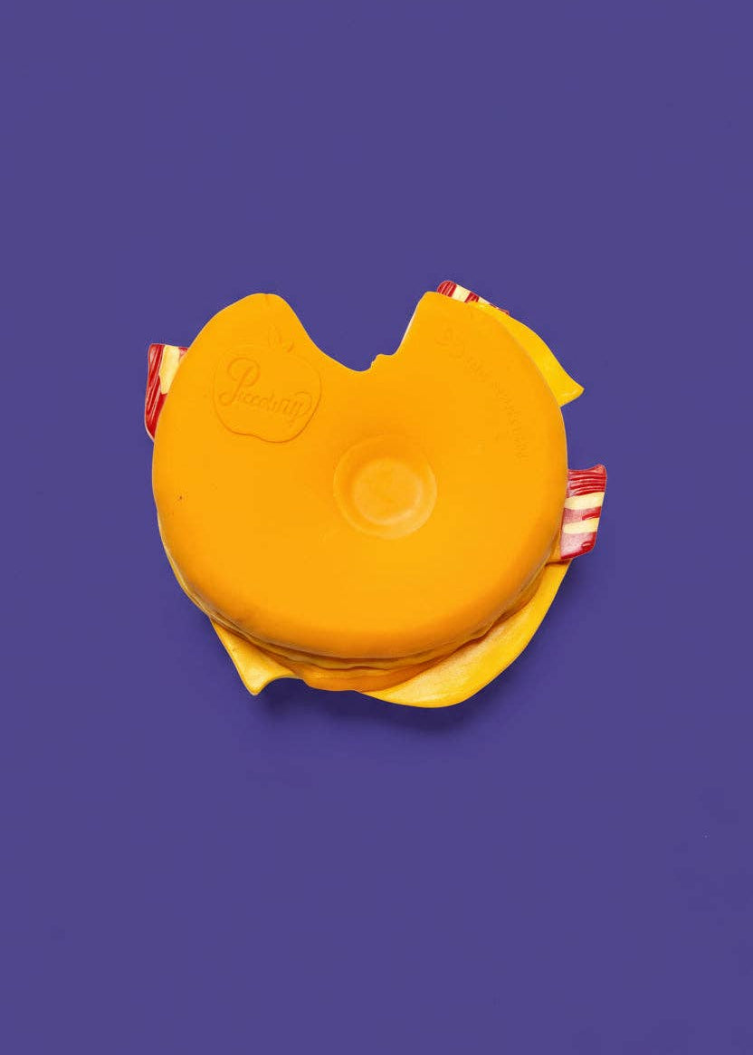 Yellow toy with red accents on a purple background
