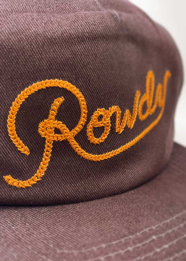 Brown cap with orange embroidered text on a white background
