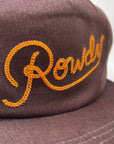 Brown cap with orange embroidered text on a white background