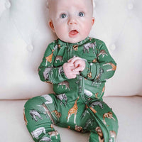 Baby wearing a green animal print onesie on a white background