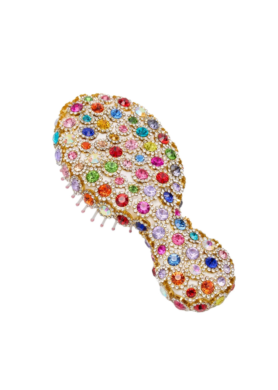 Multicolored jeweled hairbrush on a white background