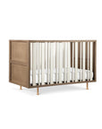 Wooden crib with white bedding on a white background