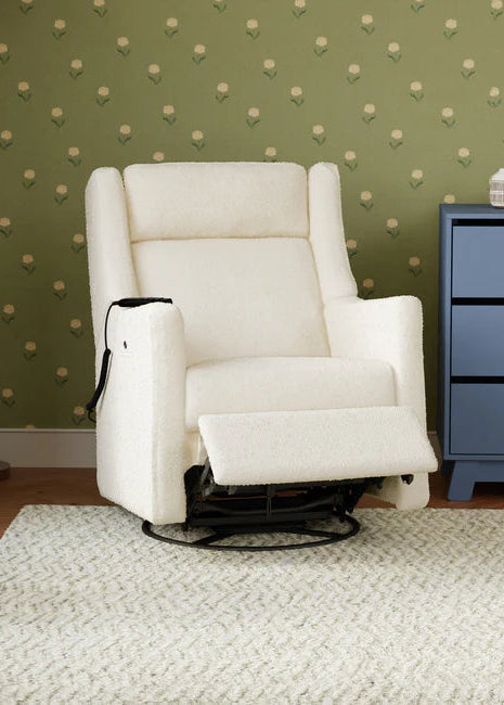White recliner chair in a room with green wallpaper and a blue dresser.