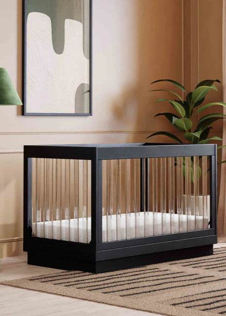 Modern crib in a stylish room with a lamp and plant