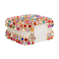 Elegant clutch with colorful gemstones on a white background