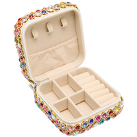 Jewelry box with colorful gemstone accents on a white background