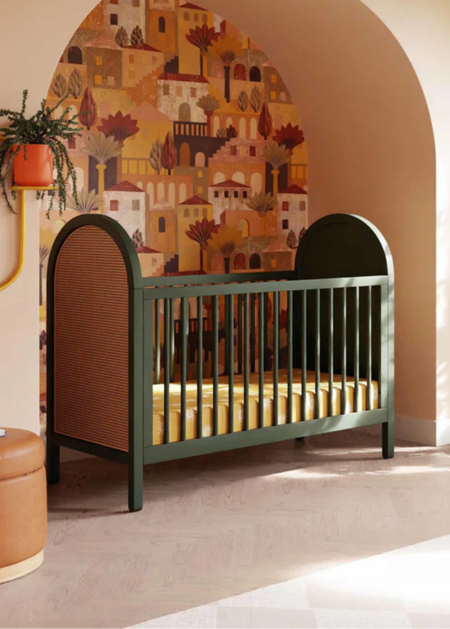 Nursery room with a green crib, decorative wall, and large window.