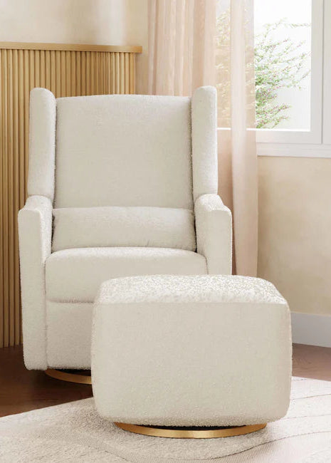 Beige armchair with matching ottoman in a room with wooden floor and window.